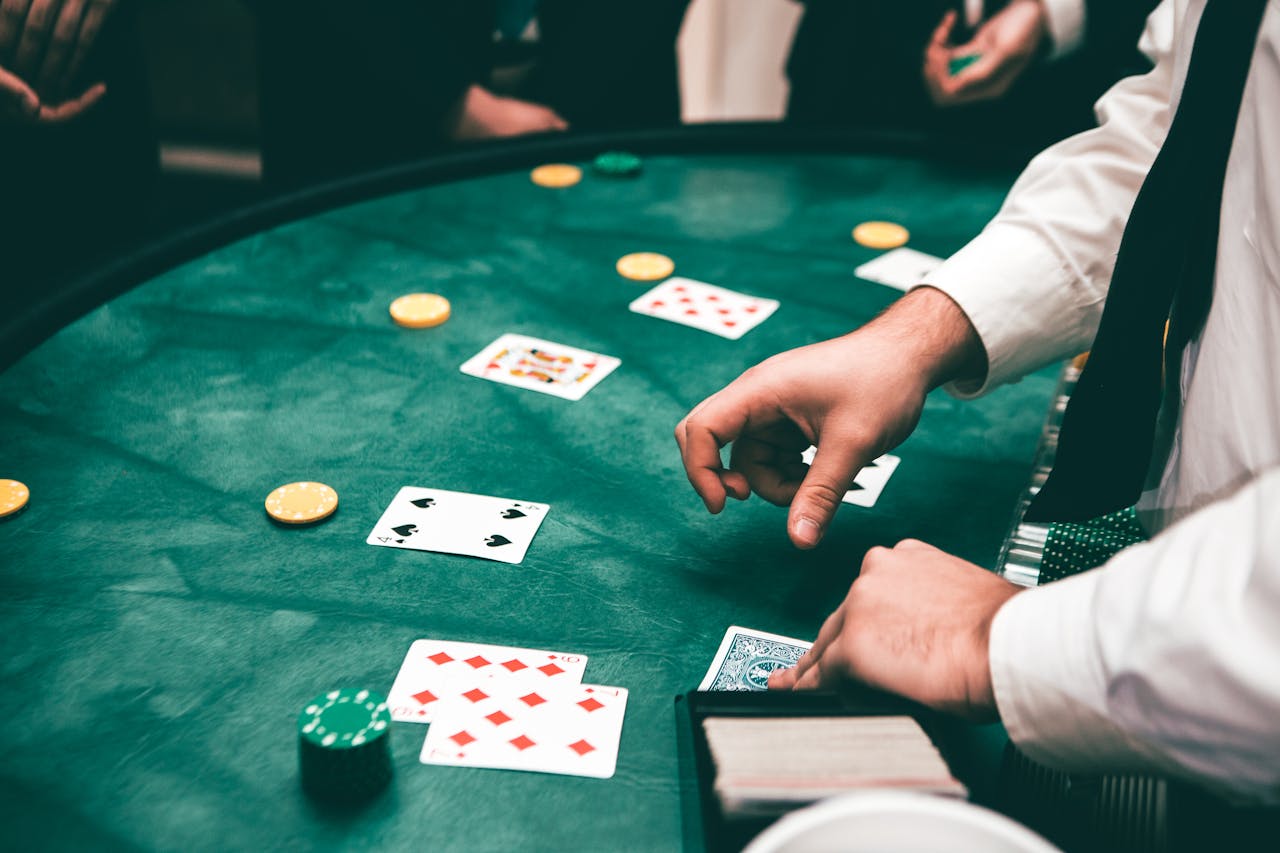 our-services-03 Casino scene with dealer and players, featuring cards and chips, creating a suspenseful atmosphere.