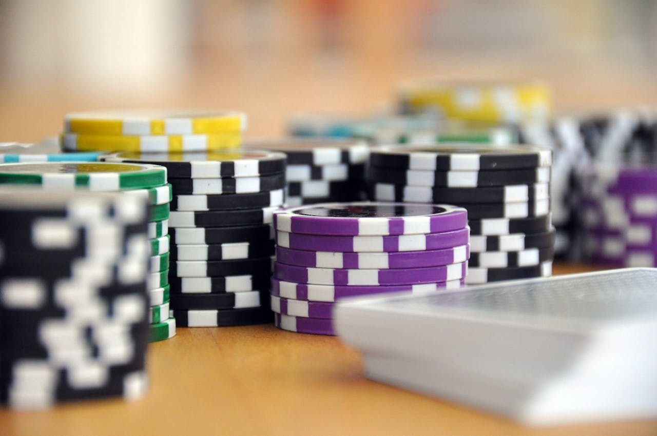 our-services-02 A close-up shot of stacked poker chips and playing cards on a table, perfect for casino and gambling themes.